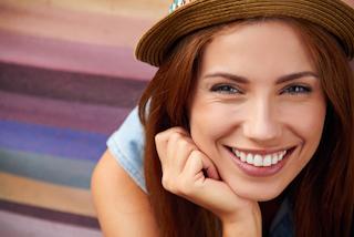 woman with hat smiling 