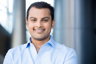 man smiling in blue shirt