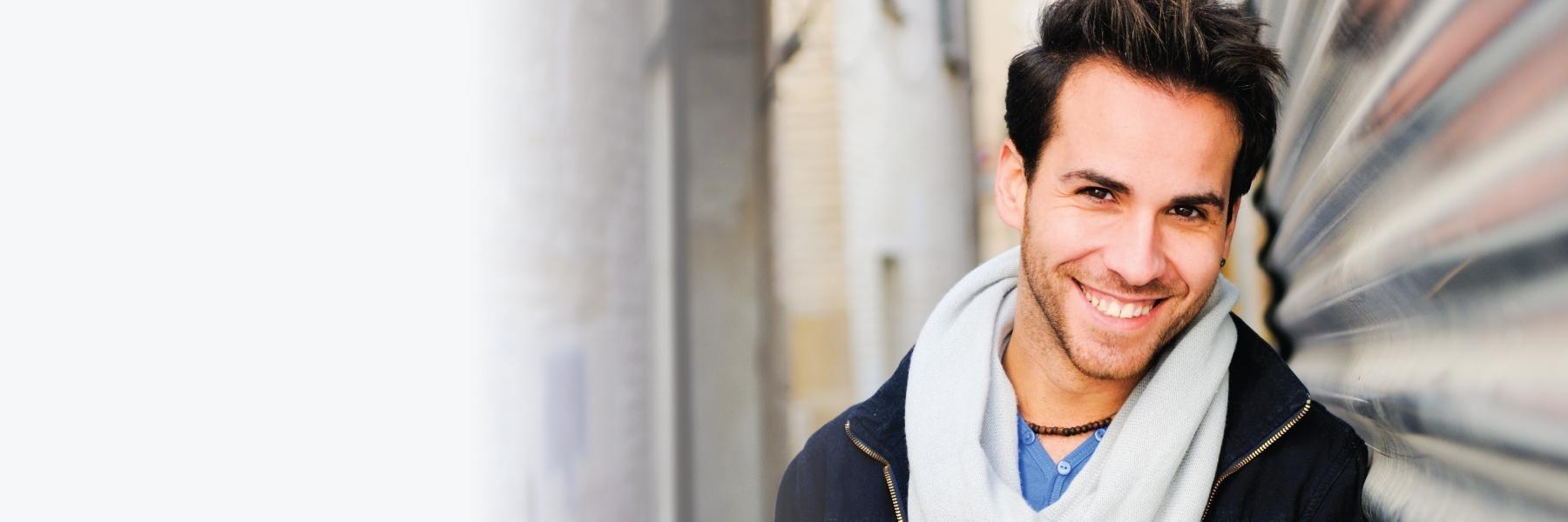 Man smiling with gray scarf